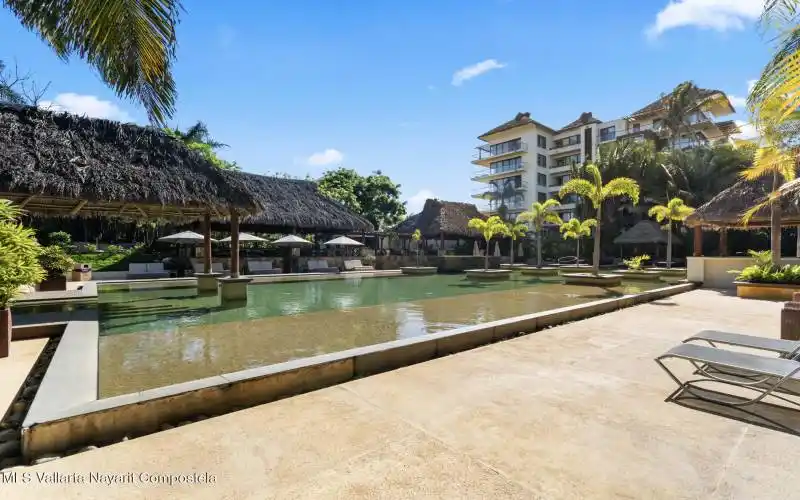 Large pool area with palapas